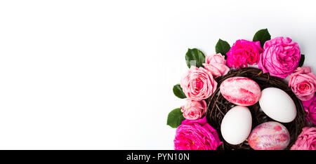 Easter eggs with fresh roses festive arrangement Stock Photo