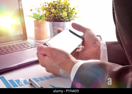 Businessman watching multimedia content on a smartphone in an office. Horizontal composition. Front view Stock Photo