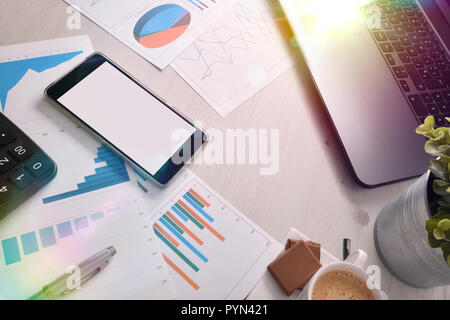 Mobile phone on in a business office on a table with business tools. Horizontal composition. Top elevated view Stock Photo