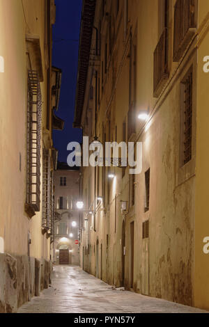 Narrow cobblestone street in  Florence, Tuscany, Italy in the summer night Stock Photo