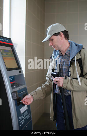 A MALE PASSENGER BUYING TRAIN TICKET FROM THE TICKET OFFICE Stock Photo ...