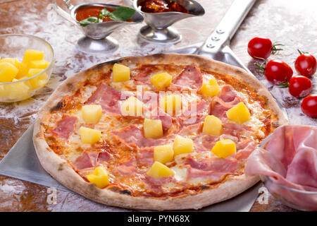 close up of tasty hawaian ham and apple pizza with ingredients Stock Photo