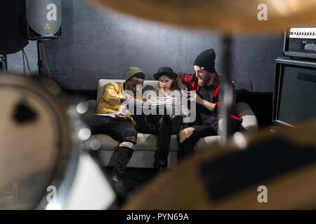 Music Band Chilling in Studio Stock Photo