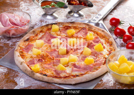 close up of tasty hawaian ham and apple pizza with ingredients Stock Photo