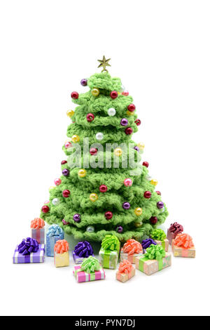 crochet christmas tree with pearls on white isolated background. Gifts under the tree. Stock Photo