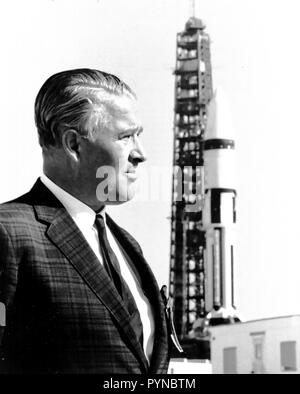 Dr. Wernher Von Braun, stands in front of a Saturn IB Launch Vehicle at Kennedy Space Center (KSC).