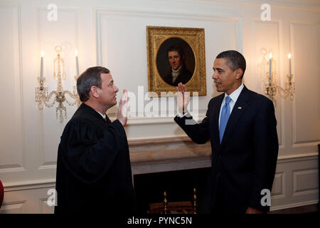 President Barack Obama is given the Oath of Office for a second time by Chief Justice John G. Roberts, Jr.  in the Map Room of the White House 1/21/09. Stock Photo