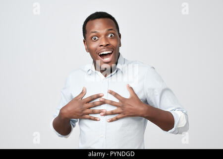Excited african man smiling and looking at camera Stock Photo