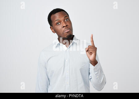 African young man showing index fingers up, giving advice Stock Photo