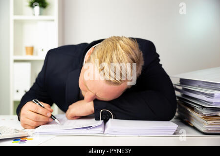 Businessman in a dark blue suit calculating sales results. Finance accounting concept Stock Photo