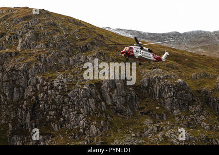 A Sikorsky S-92A Helibus from the UK Coastguard, G-MCGK, operating as a search and rescue helicopter in the Snowdonia National Park in North Wales. Stock Photo