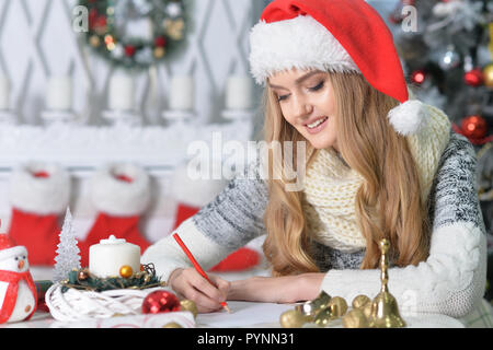 Portrait of a beautiful young beautiful woman in Santa hat Stock Photo