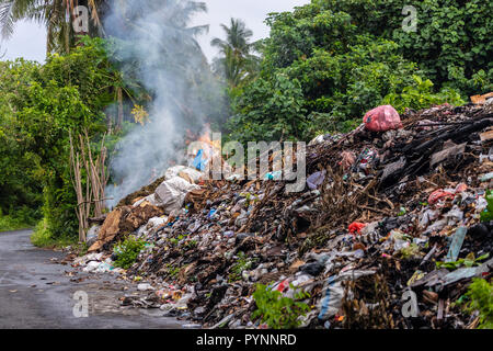 Tons of industrial rubbish burning along the road in the Banda Neira island, Indonesia