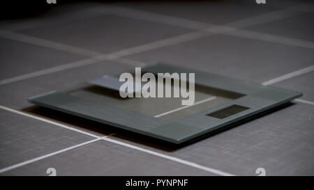 Glass modern design digital weight scales in bathroom on tiled floor Stock Photo