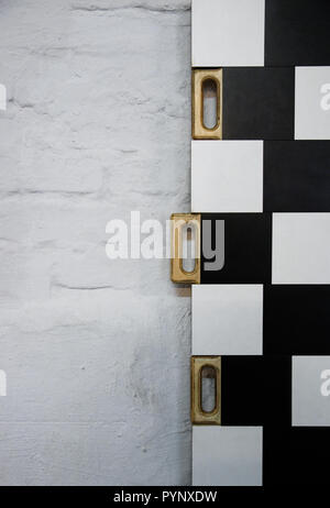 half black and white random checkered texture wooden handles to move the boards to the sides of the background. Stock Photo