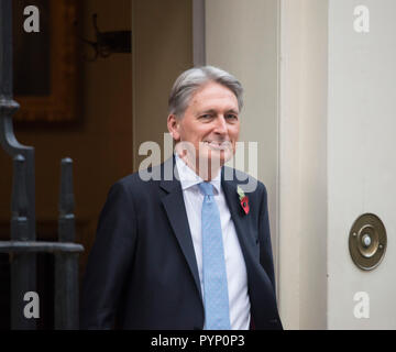 11 Downing Street, London, UK. 29 October, 2018. British Chancellor of the Exchequer Philip Hammond shows the traditional red budget case to assembled media before travelling to Parliament to present his Autumn Budget. Credit: Malcolm Park/Alamy Live News. Stock Photo