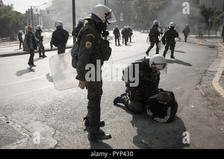 A student seen being arrested by a police officer during the protest. Hundreds of students protested against the New Lyceum and said they were determined to claim 'the school and the life they deserve'. Students argue that the changes promoted by the Education Ministry deprive them of the right to education. Stock Photo