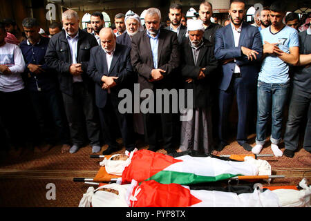 October 29, 2018 - The funeral of three boys killed last night by an Israeli airstrike close to the fence dividing Gaza and Israel takes place in the Al-Hikma mosque in the Deir Al-Balah city, in the central Gaza strip on 29 October 2018. The head of Hamas political bureau, Ismail Haniyeh, the senior member of the political bureau of the Islamic Jihad, Khaled al-Batsh, and the deputy speaker of the Palestinian Legislative Council, Ahmed Bahr, attended the ceremony at the mosque. Khaled Bassam Mahmoud Abu Saeed, 14, Abdul Hameed Mohammed Abdul Aziz Abu Zaher, 13, and Mohammed Ibrahim Abdullah A Stock Photo