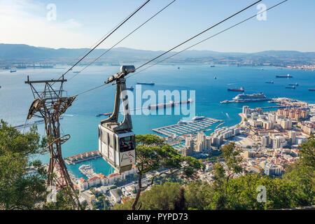 View over the Bay of Gibraltar from the Rock of Gibraltar showing the tourist styled cable car travelling from Gibraltar town to the top of the Rock Stock Photo