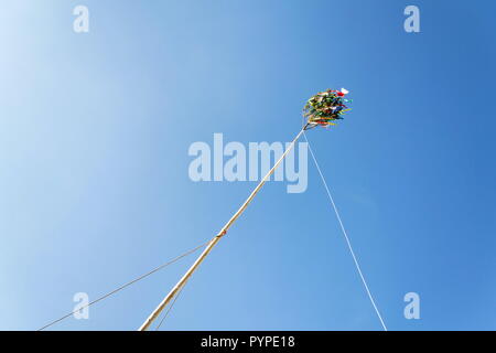 Traditional tall wooden maypole erected with ribbons and small Czech flag Stock Photo