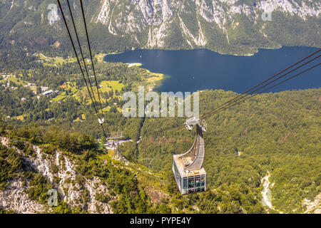 Gondola ski lift in summer taking hikers into the mountains overlooking lake Bohinj near Bled, Slovenia Stock Photo