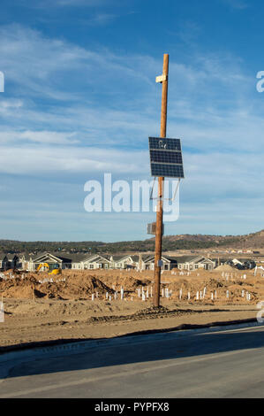 Solar panel on a pole used to power a security camera Stock Photo