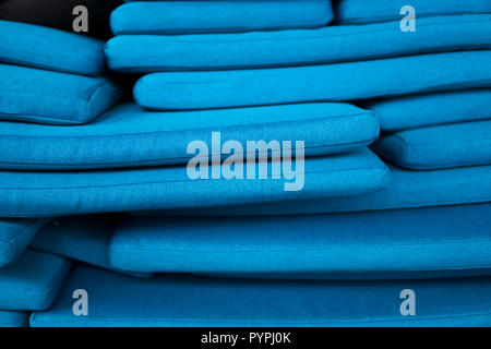 The mountain of blue pillows lie on one another. Pillow texture. Stock Photo
