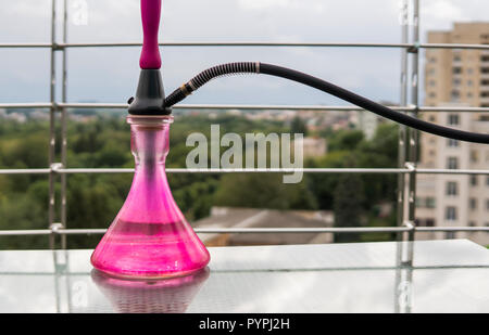 Pink hookahs on table in hookah lounge in a day. Stock Photo