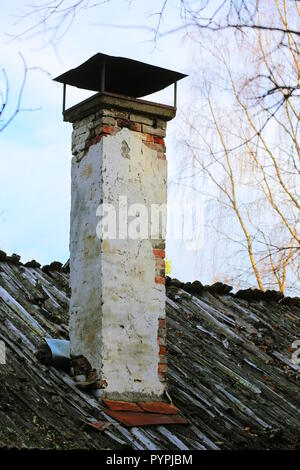 Old Chimney on a wooden lath roof. Stock Photo