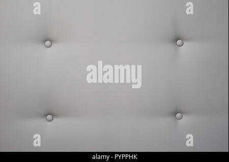 Creamy leather sofa background with buttons as a texture. Stock Photo