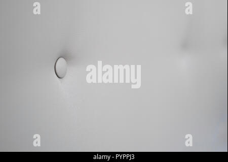 Creamy leather sofa background with buttons as a texture. Stock Photo