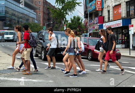 New York City, NY USA. Jul 2014. Teenagers on a busy New York city crosswalk on the way to school. Stock Photo