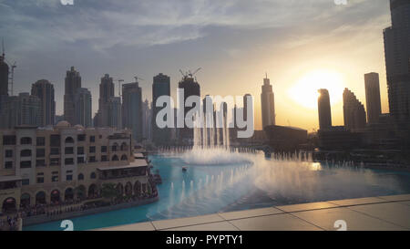 Dubai Fountain is the world's largest choreographed fountain system on sunset background Stock Photo