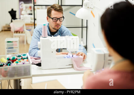 Man working on sewing machine Stock Photo