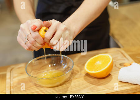 close-up scene of squeezing oranges on kitchen selective focus Stock Photo