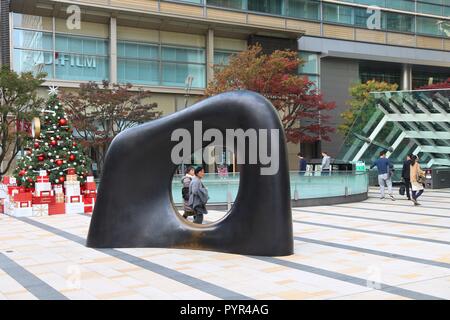 TOKYO, JAPAN - DECEMBER 1, 2016: People visit Tokyo Midtown office and shopping complex. The district project was completed in 2007 at a cost of 3 bil Stock Photo