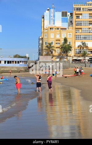 LAS PALMAS, SPAIN - NOVEMBER 30, 2015: People visit Las Canteras Beach in Las Palmas, Gran Canaria, Spain. Canary Islands had record 12.9 million visi Stock Photo