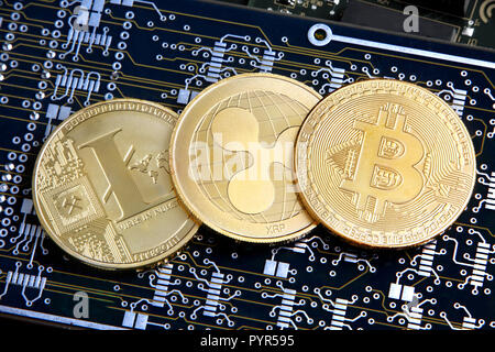 Litecoin, Ripple & Bitcoin golden coins representing cryptocurrenies. Stock Photo