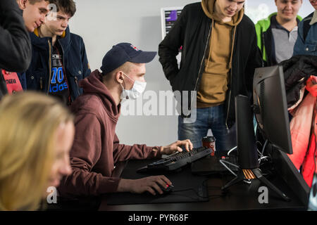 MOSCOW, RUSSIA - OCTOBER 27 2018: EPICENTER Counter Strike: Global Offensive esports event. Young man playing a game on a pc computer wearing the mask. Stock Photo