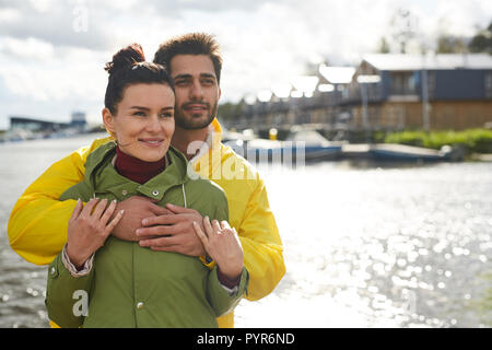 Happy dreamy couple contemplating seascape together Stock Photo