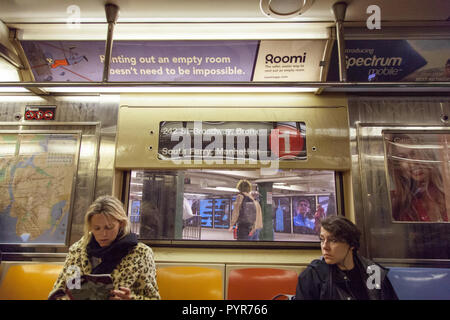 Women on the New York Subway line 1 South Ferry, Manhattan, New York City, United States of America. Stock Photo