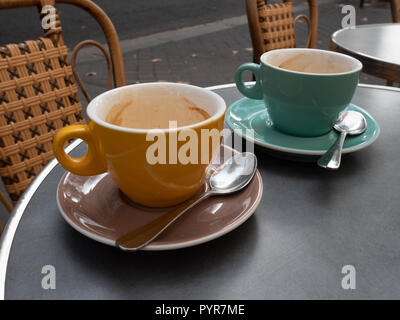 View of Two Empty Coffee Cups on Street Cafe Table Stock Photo