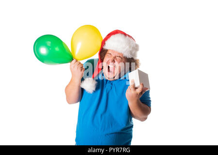 Funny fat man in Santa hat with balloons and gifts. Christmas and presents. Emotions Stock Photo