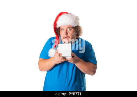 Funny fat man in Santa hat with gifts. Christmas and presents. Emotions Stock Photo