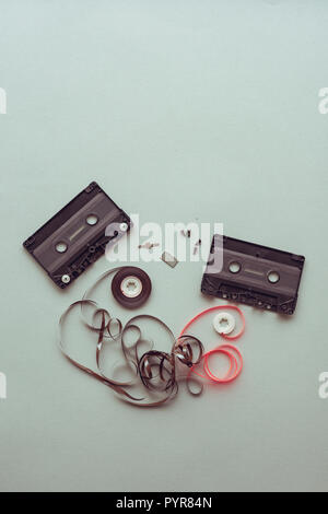 Flat lay audio cassette parts on pastel blue background, top view of retro technology and media concept Stock Photo