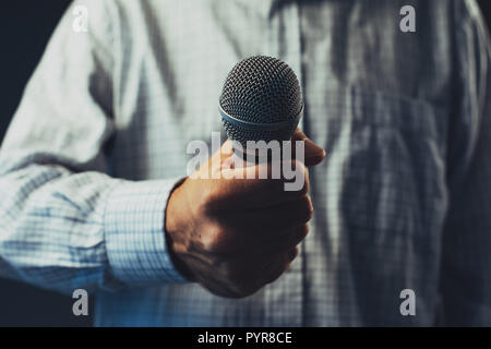 Hand with microphone doing an interview for the media, selective focus Stock Photo