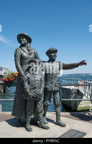 Statue of Annie Moore in Cobh, County Cork, Ireland, with her brothers, first Irish immigrant to the United States in 1892 Stock Photo