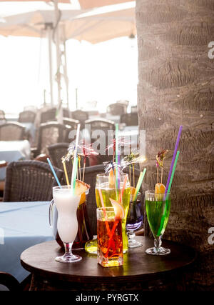 mixed cocktails showed and exposed on a bar of a outdoor bar restaurant without people sitting and buying. colours and samples of what the barman coul Stock Photo