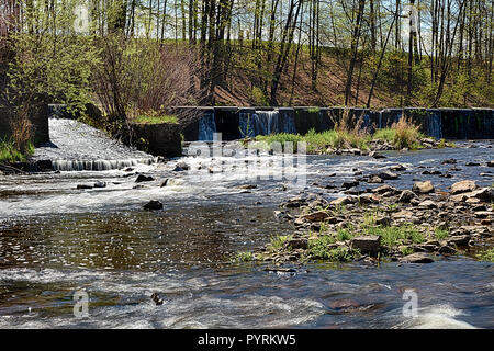 River with the weir runs over boulders Stock Photo