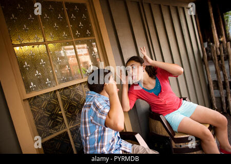 Brother and sister playfully making faces at one another. Stock Photo